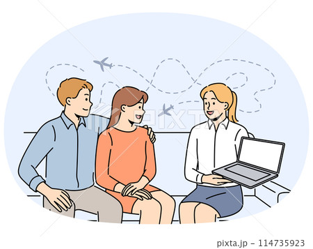 Tour operator showing offer on laptop to clients 114735923