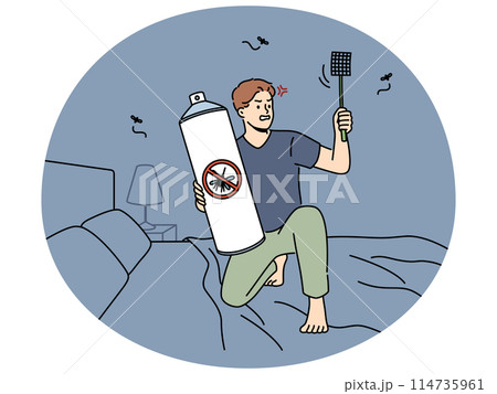 Angry man with flyswatter aerosol from mosquitos at home 114735961