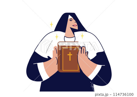 Woman nun holds holy bible in hands and demonstrates main Christian book to parishioners 114736100
