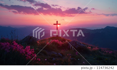 Silhouette of a cross on a hill in a mountain landscape at sunset. 114736242