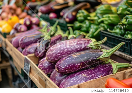 Fresh organic eggplants in a wooden crate on a market 114736410