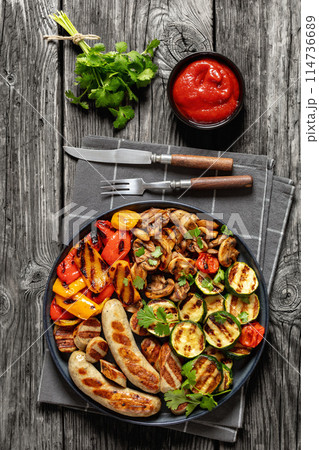 grilled white sausages with veggies and mushrooms grilled white sausages with veggies and mushrooms 114736689