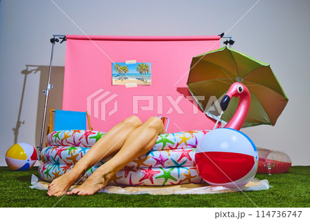 Person enjoying laid-back moment in inflatable pool. Cheerful and carefree summer vibe. Concept of travelling, party time. 114736747