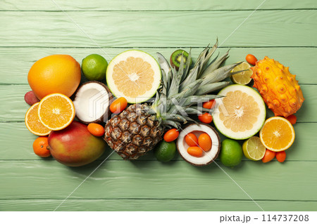 Set of tropical fruit on green wooden background, top view Set of tropical fruit on green wooden background, top view 114737208