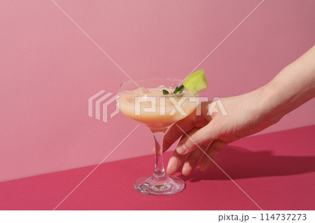 A glass of fresh melon juice on a pink background A glass of fresh melon juice on a pink background 114737273