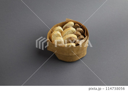 Italian ciabatta bread or bun in a box on the grey background. Freshly baked traditional bread Italian ciabatta bread or bun in a box on the grey background. Freshly baked traditional bread 114738056