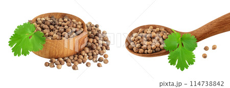 Dried coriander seeds in the wooden bowl and spoon with fresh green leaf isolated on white background 114738842