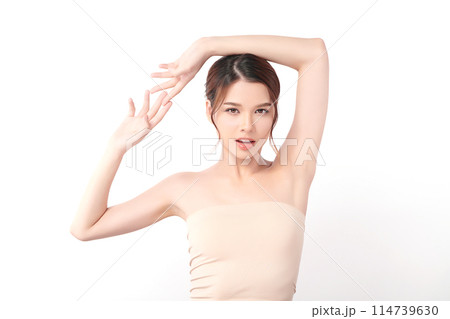 Beautiful Young Asian woman lifting hands up to show off clean and hygienic armpits or underarms on white background, Smooth armpit cleanliness and protection concept 114739630