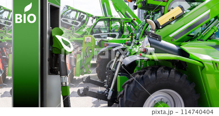 Biofuel filling station on a background of green construction machines. Decarbonization of heavy industrial vehicles 114740404