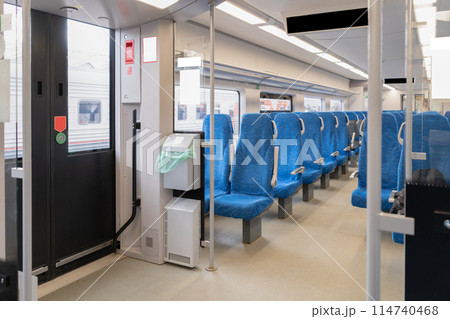 Inside The Wagon Train. Interior of the passenger train with empty blue fabric seats. High quality photo 114740468