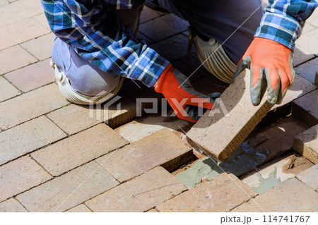 Pavement that has been destroyed by brick path is being rebuilt as replacement 114741767