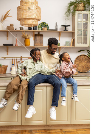 Playful small kids girl having fun with smiling bearded father at home Playful small kids girl having fun with smiling bearded father at home 114744159