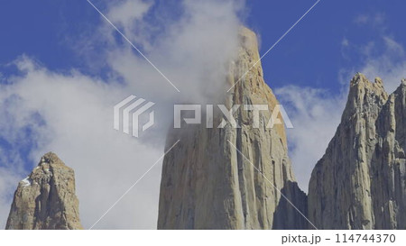 Majestic Torres del Paine Peaks Piercing the Cloudy Sky 114744370