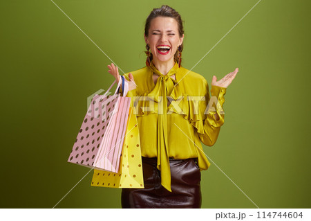 happy healthy female rejoicing on green background happy healthy female rejoicing on green background 114744604