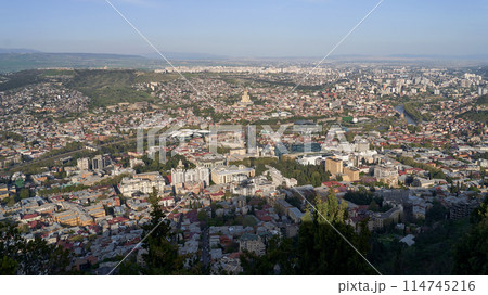 Wide angle view of beautiful city if Tbilisi and Kura river from Mount Mtatsminda with Holy Trinity Cathedral in the center and Old Town on the right side 114745216