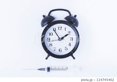 Time for vaccination. Watch and syringe with vaccine. Date and time of preventive vaccinations to population. Time for vaccination. Watch and syringe with vaccine. Date and time of preventive vaccinations to population. 114745402