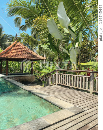 Swimming pool and traditional Balinese gazebo 114745442