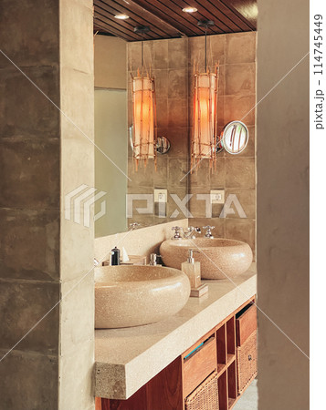 Two luxury faucet mixer on a round bowl stone sink Two luxury faucet mixer on a round bowl stone sink 114745449