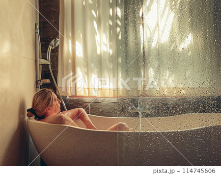 Middle aged woman taking a bath Middle aged woman taking a bath 114745606