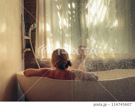 Middle aged woman taking a bath Middle aged woman taking a bath 114745607