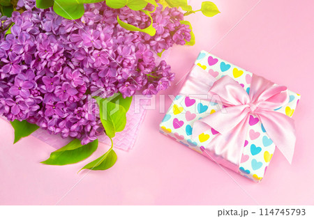 beautiful dark purple fresh lilac on the pink background, purple background 114745793