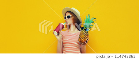 Summer portrait of stylish young woman drinking fresh juice with pineapple fruit Summer portrait of stylish young woman drinking fresh juice with pineapple fruit 114745863