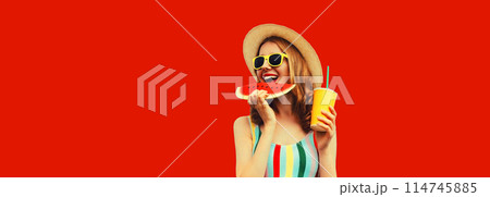 Summer happy young woman eating fresh juicy slice of watermelon with cup of juice on red background Summer happy young woman eating fresh juicy slice of watermelon with cup of juice on red background 114745885