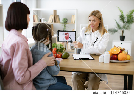 Female doctor showing tablet with gastrointestinal tract. Female doctor showing tablet with gastrointestinal tract. 114746085