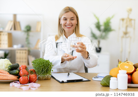 Portrait of mature lady posing with glass of clean water. 114746938