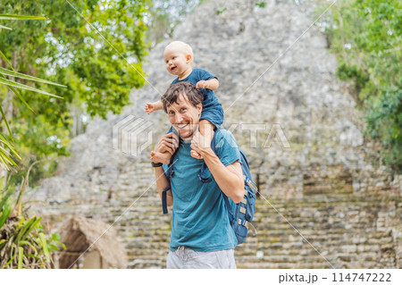 Dad and son tourists at Coba, Mexico. Ancient mayan city in Mexico. Coba is an archaeological area and a famous landmark of Yucatan Peninsula. Cloudy sky over a pyramid in Mexico 114747222