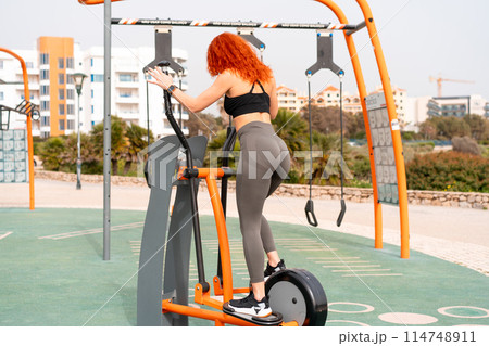Fit woman exercising with exercise equipment in Fit woman exercising with exercise equipment in 114748911