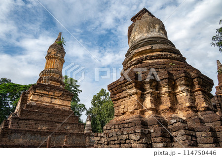 Group of ancient pagoda in Wat Chedi Jet Thaew the largest temple compound in Si Satchanalai Historical Park of Sukhothai province of Thailand. This temple consists of 32 chedis in various style. Group of ancient pagoda in Wat Chedi Jet Thaew the largest temple compound in Si Satchanalai Historical Park of Sukhothai province of Thailand. This temple consists of 32 chedis in various style. 114750446