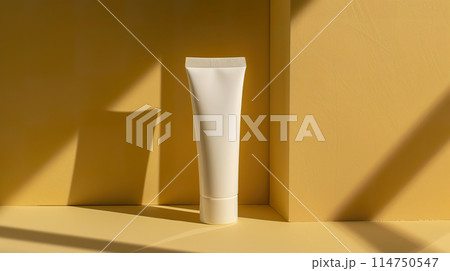 White sunscreen cosmetic tube mockup with shadows on bright yellow background in a minimalist setting 114750547