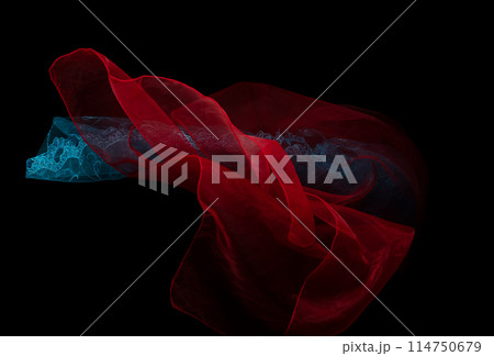 Red organza blue lace fabric flying in curve shape, Piece of textile white organza blue lace fabric throw fall in air. Black background isolated, dark shading environment Red organza blue lace fabric flying in curve shape, Piece of textile white organza blue lace fabric throw fall in air. Black background isolated, dark shading environment 114750679