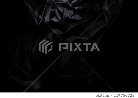 Black wrinkle mussed fabric flying in curve shape, Piece of textile Black wrinkle mussed fabric throw fall in air. Black background isolated, dark shading environment Black wrinkle mussed fabric flying in curve shape, Piece of textile Black wrinkle mussed fabric throw fall in air. Black background isolated, dark shading environment 114750729