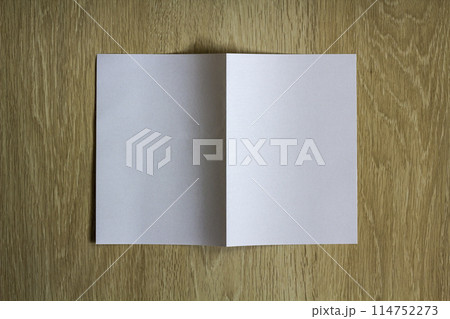 Blank white piece of paper on wooden background 114752273