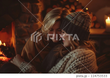 Sharing heat and art in a dark room by the fireplace Sharing heat and art in a dark room by the fireplace 114753533