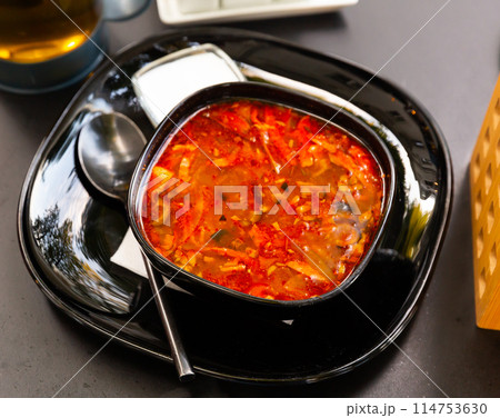 Russian cuisine - solyanka soup with various ingredients closeup 114753630