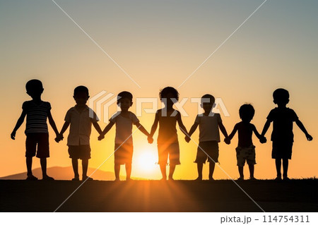 Children silhouettes holding hands 114754311