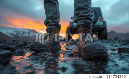 Hiking boots on volcanic terrain at sunset 114754369