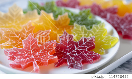 A close-up of colorful maple leaves made from sugar candies on a white plate 114758435