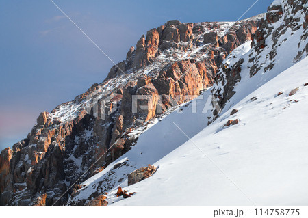 Beautiful amazing landscape of snowy mountains with picturesque red rock in central Asia in the Tian Shan mountains in Kazakhstan near Almaty. 114758775