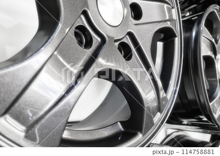 Close-up view of alloy wheels designed for passenger cars. Close-up view of alloy wheels designed for passenger cars. 114758881