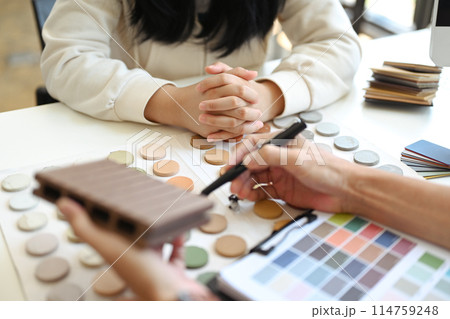 Cropped of female costumer discussing home renovation with interior designer Cropped of female costumer discussing home renovation with interior designer 114759248