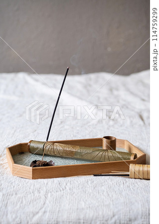 Stick of incense burning on glass tray. Stick of incense burning on glass tray. 114759299
