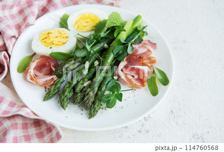Fresh Asparagus and Prosciutto Salad Served With Boiled Eggs and Microgreens Fresh Asparagus and Prosciutto Salad Served With Boiled Eggs and Microgreens 114760568