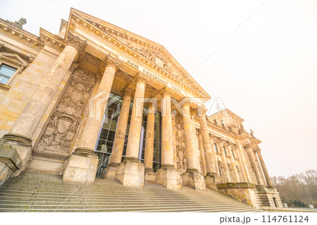The Reichstag Building bathes in the warm glow of the setting sun, highlighting its neoclassical architecture. The seat of the German Bundestag, Berlin, Germany. 114761124