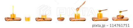 Wooden bowl full of honey and wooden dipper on wooden plank isolated on white 114761751