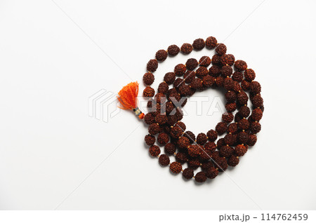 Wooden church rosary made of dark wood on a white background. Church rosary for prayer close-up 114762459