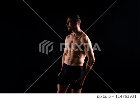 Portrait of man, bodybuilder and bicep flex in studio, background and exercise for muscular power. 114762931